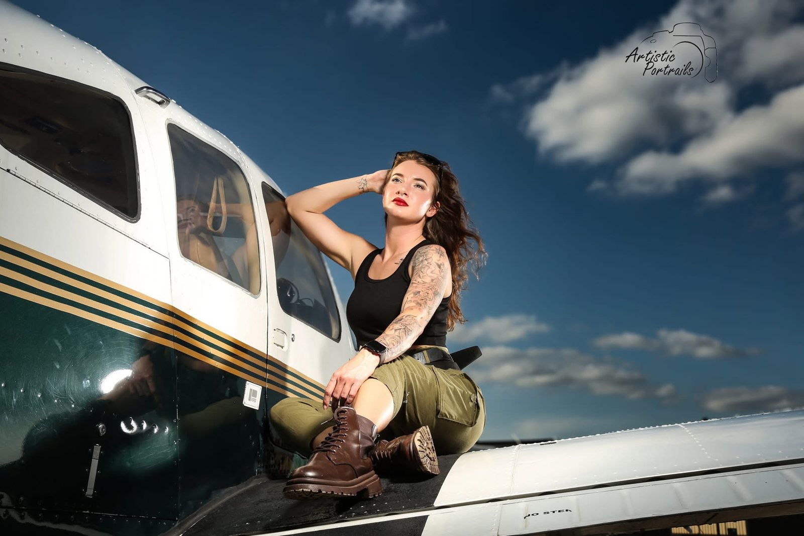 Rachel McFarland sitting on the wing of an airplane